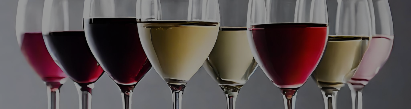 A row of wine glasses with different varieties of wine displayed within each glass